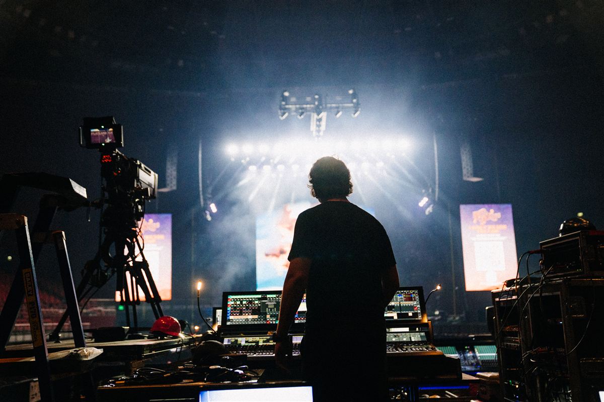 Chris Haynes silhouetted against white beams at the desk in Sydney